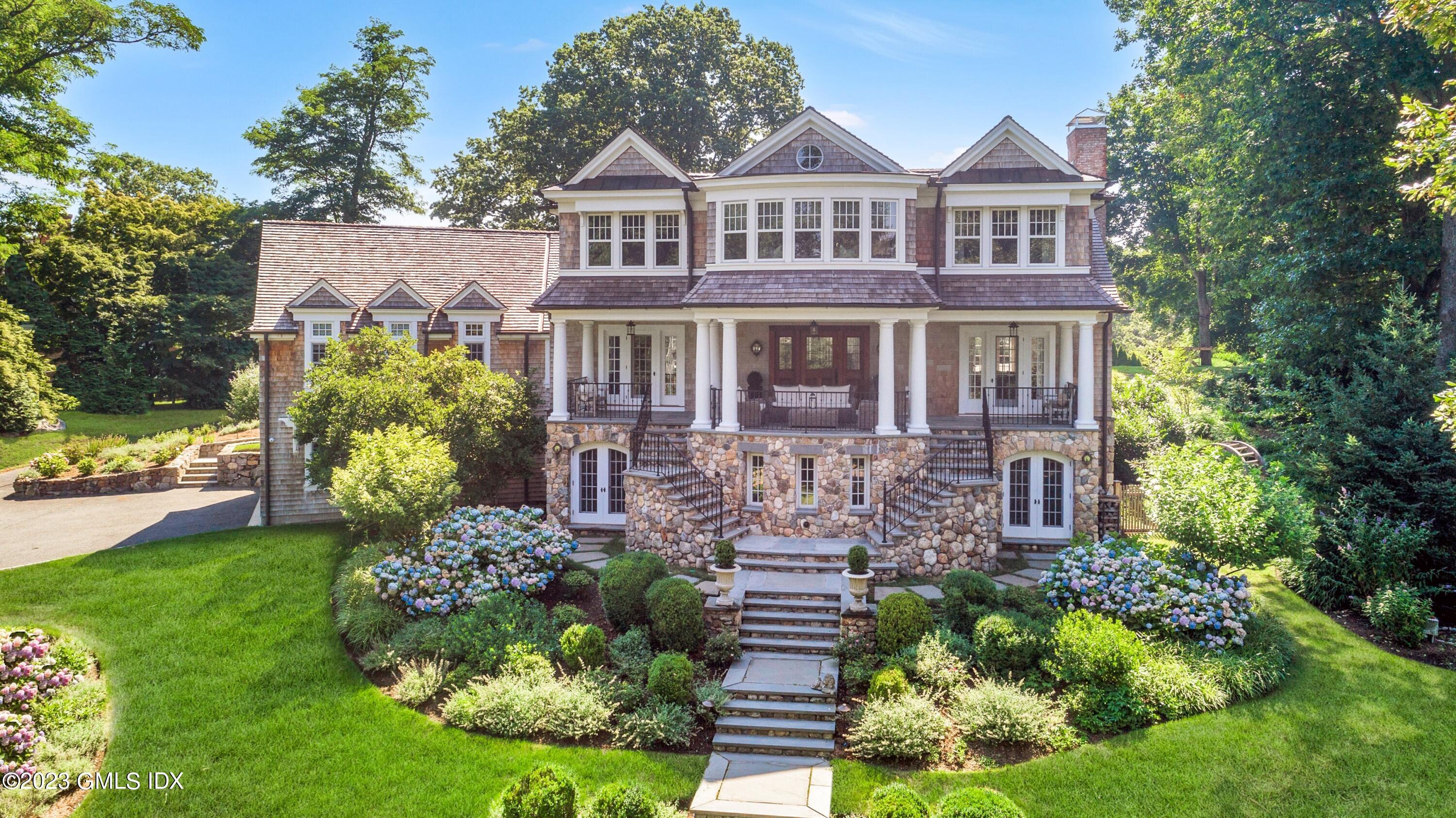 150 Goodwives River Road Darien, CT 06820 - Photo 2 of 39 a front view of a house with garden