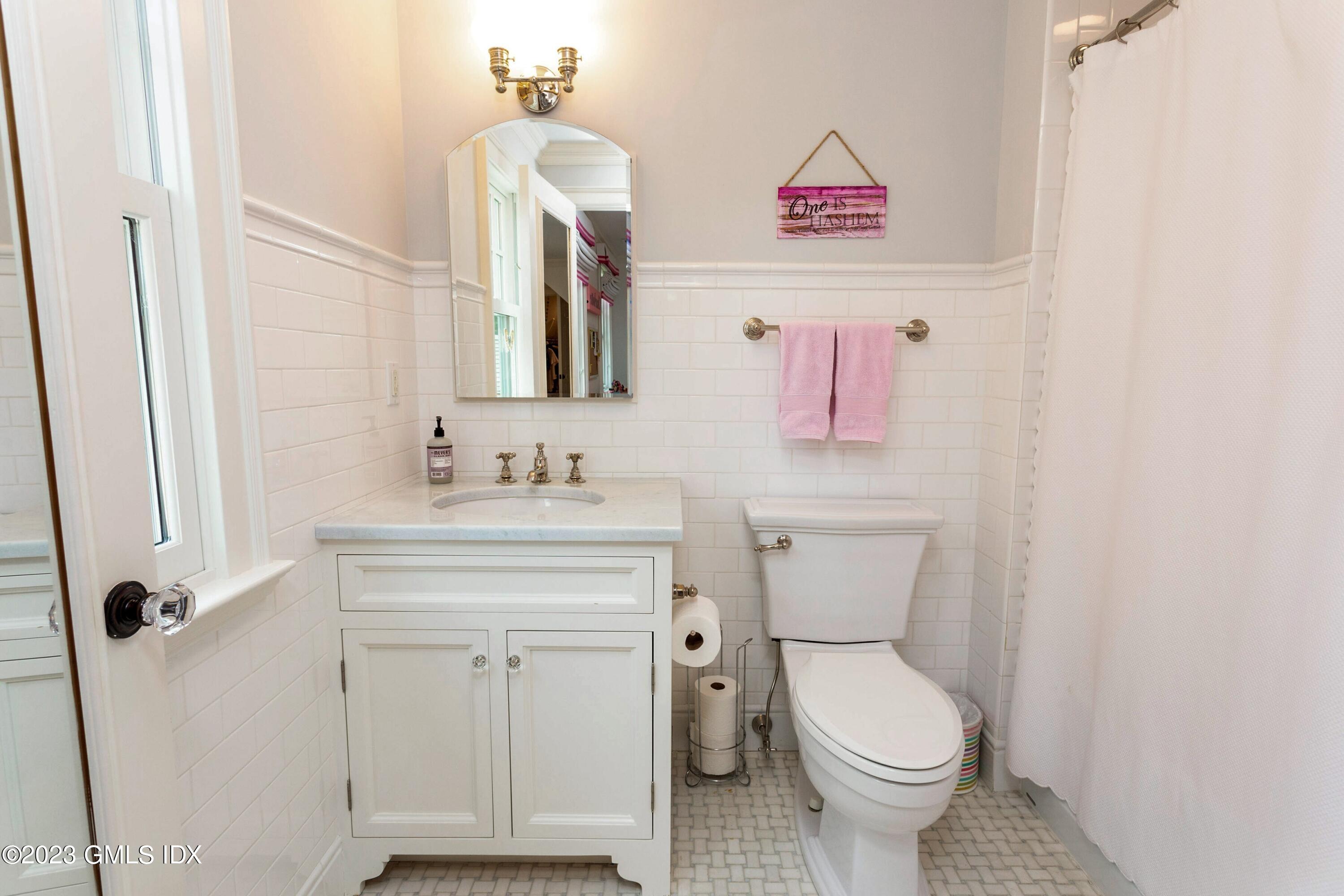 150 Goodwives River Road Darien, CT 06820 - Photo 22 of 39 a bathroom with a toilet a sink and a mirror