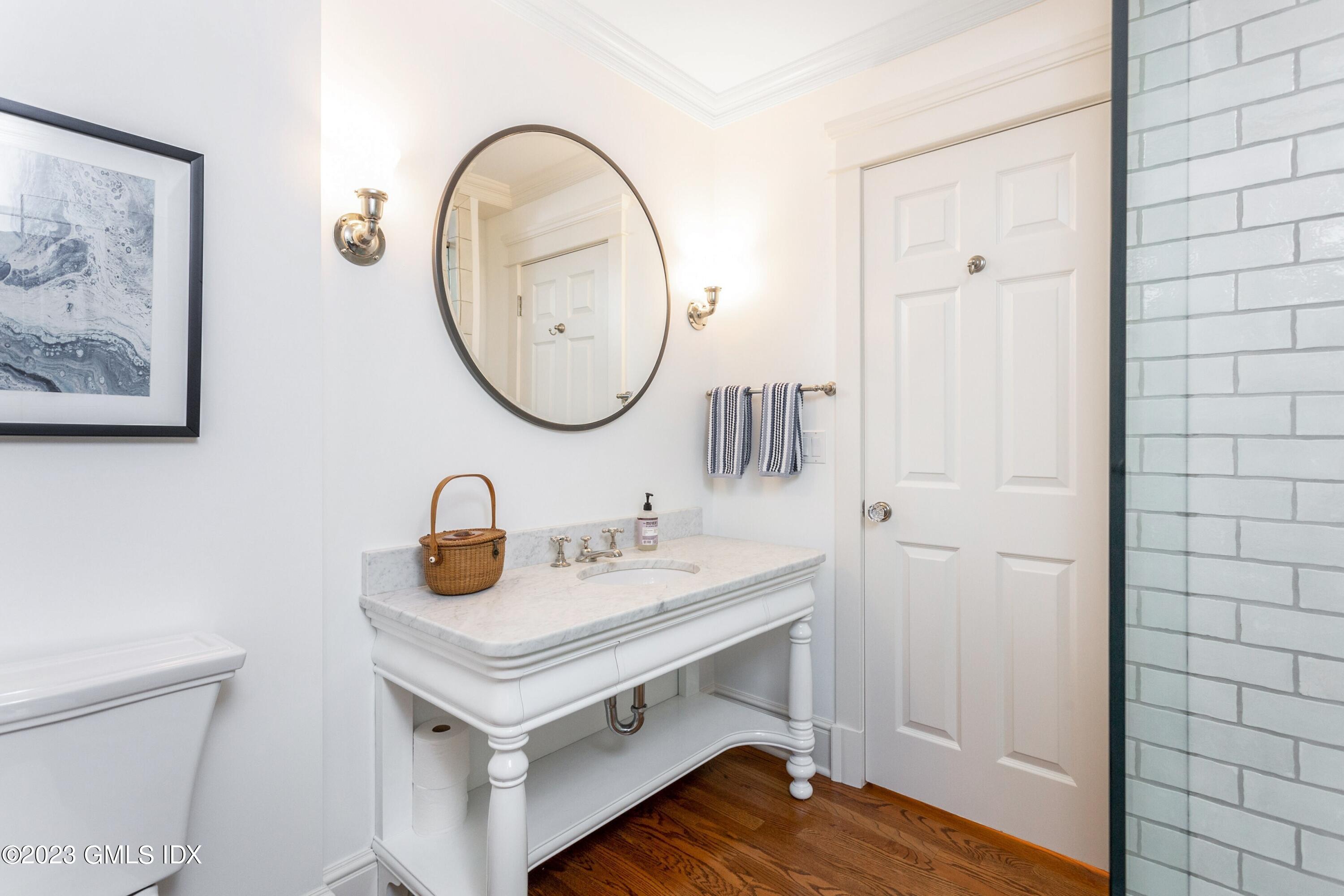 150 Goodwives River Road Darien, CT 06820 - Photo 27 of 39 a bathroom with a sink and a mirror