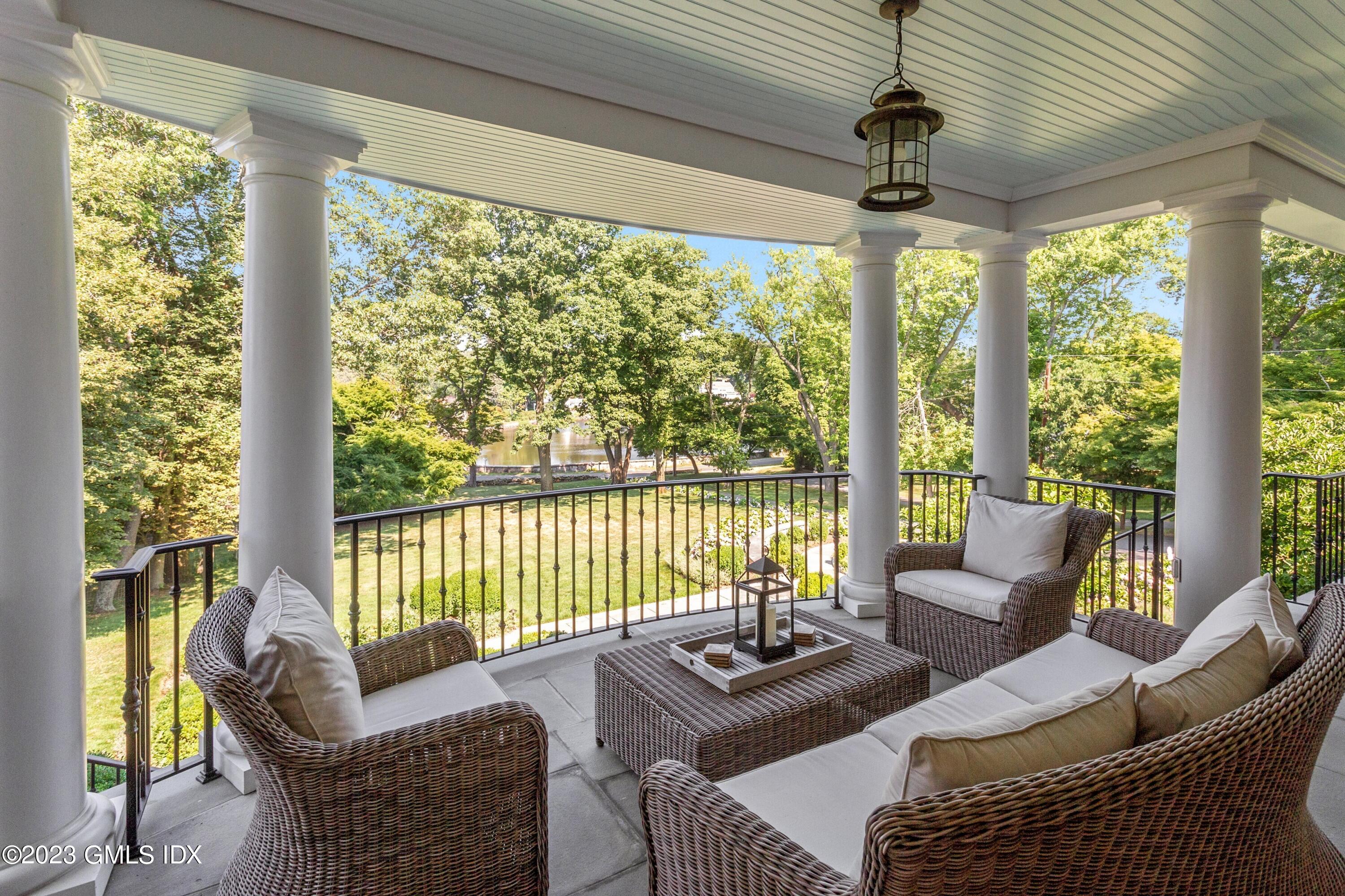 150 Goodwives River Road Darien, CT 06820 - Photo 3 of 39 a living room with furniture and a floor to ceiling window