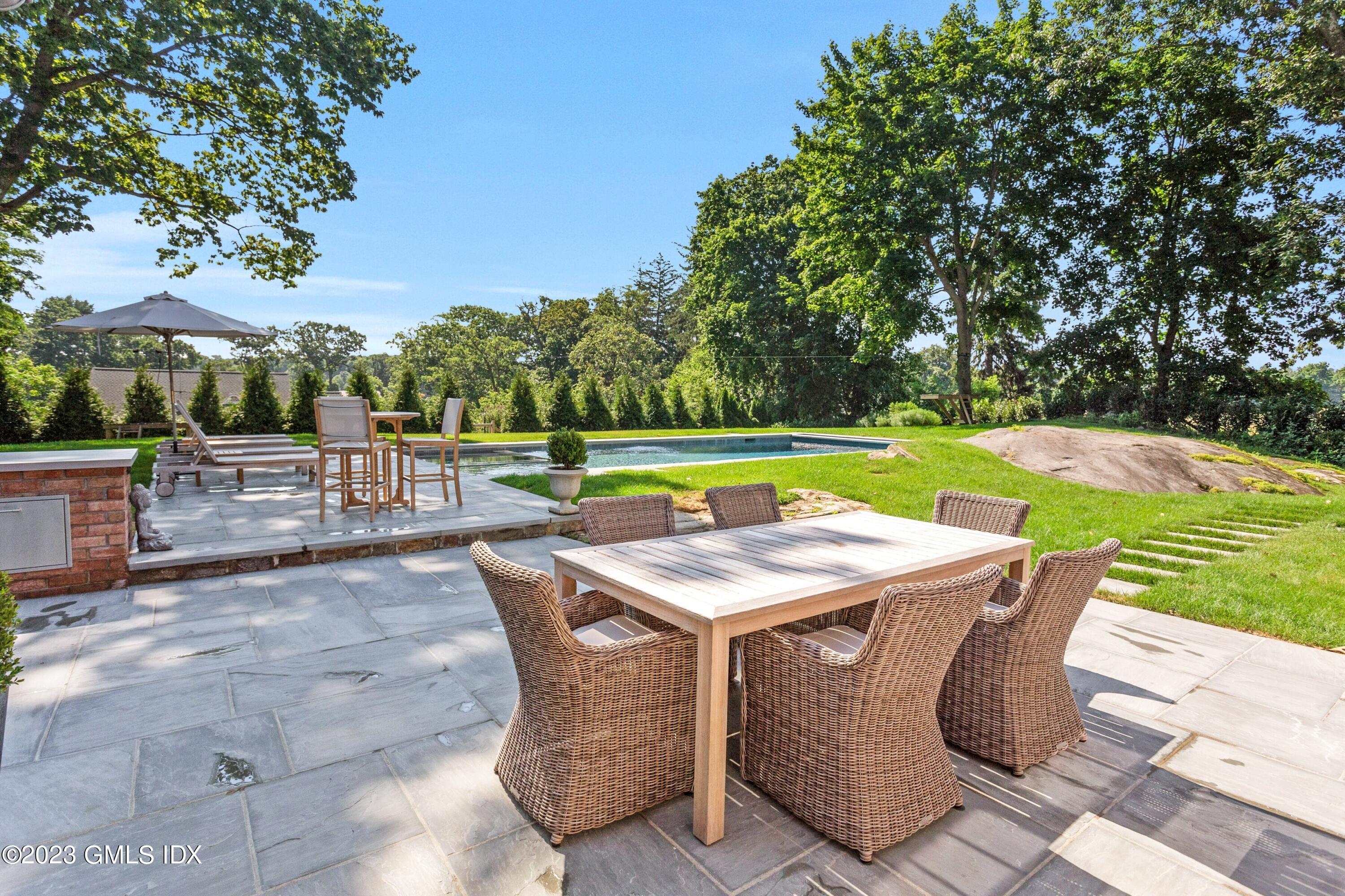 150 Goodwives River Road Darien, CT 06820 - Photo 32 of 39 a view of a swimming pool with a patio