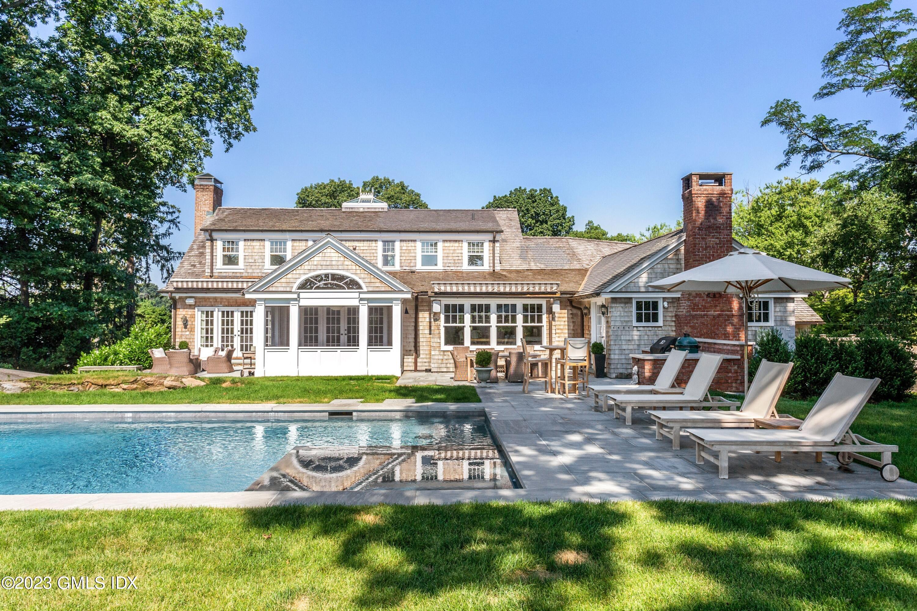 150 Goodwives River Road Darien, CT 06820 - Photo 33 of 39 a front view of a house with garden