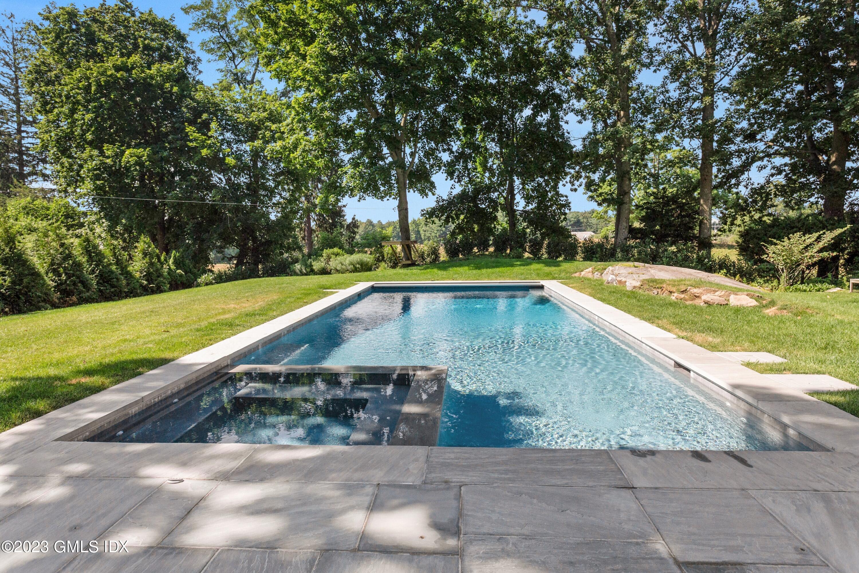 150 Goodwives River Road Darien, CT 06820 - Photo 34 of 39 a view of a swimming pool with a yard