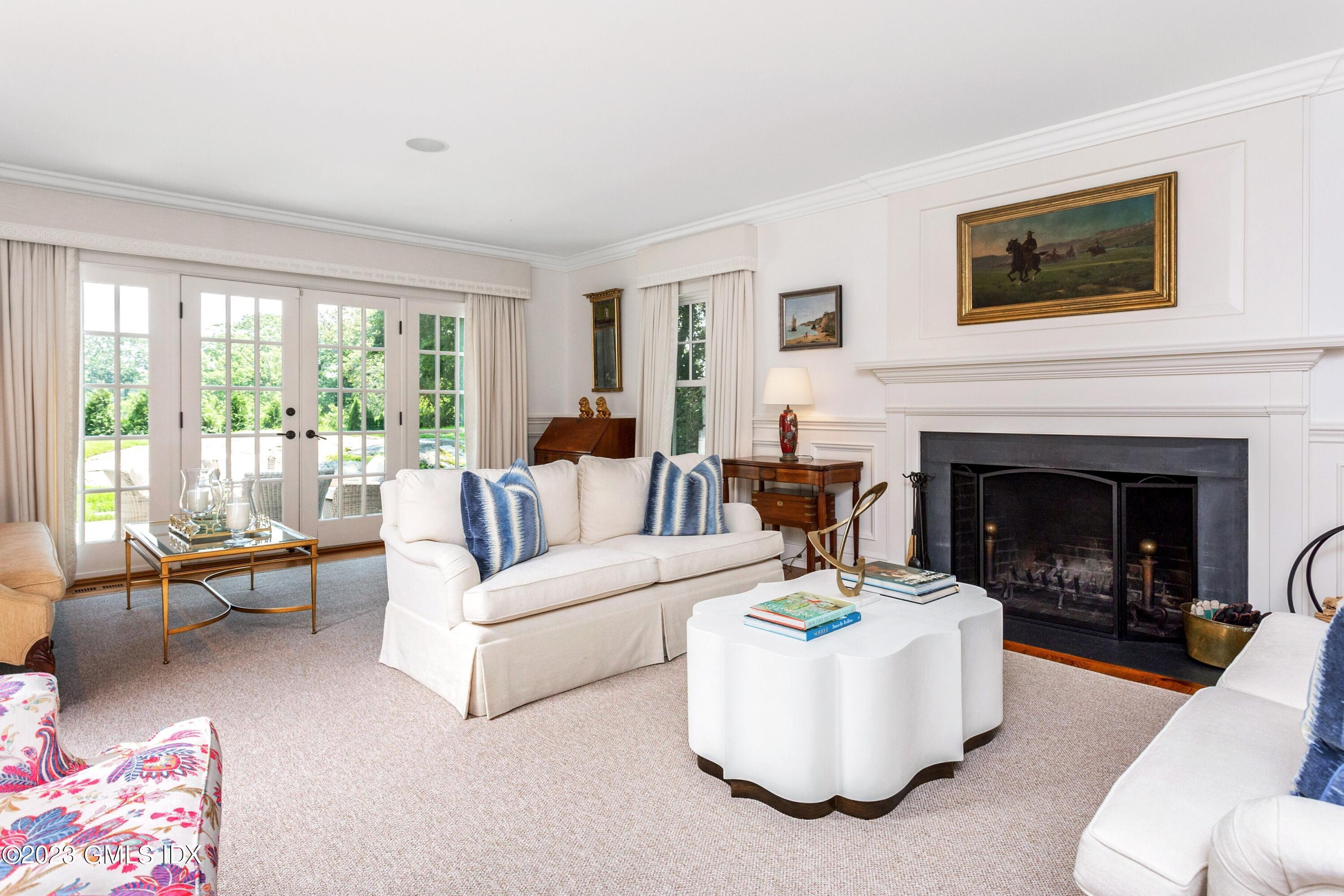 150 Goodwives River Road Darien, CT 06820 - Photo 6 of 39 a living room with furniture and a fireplace