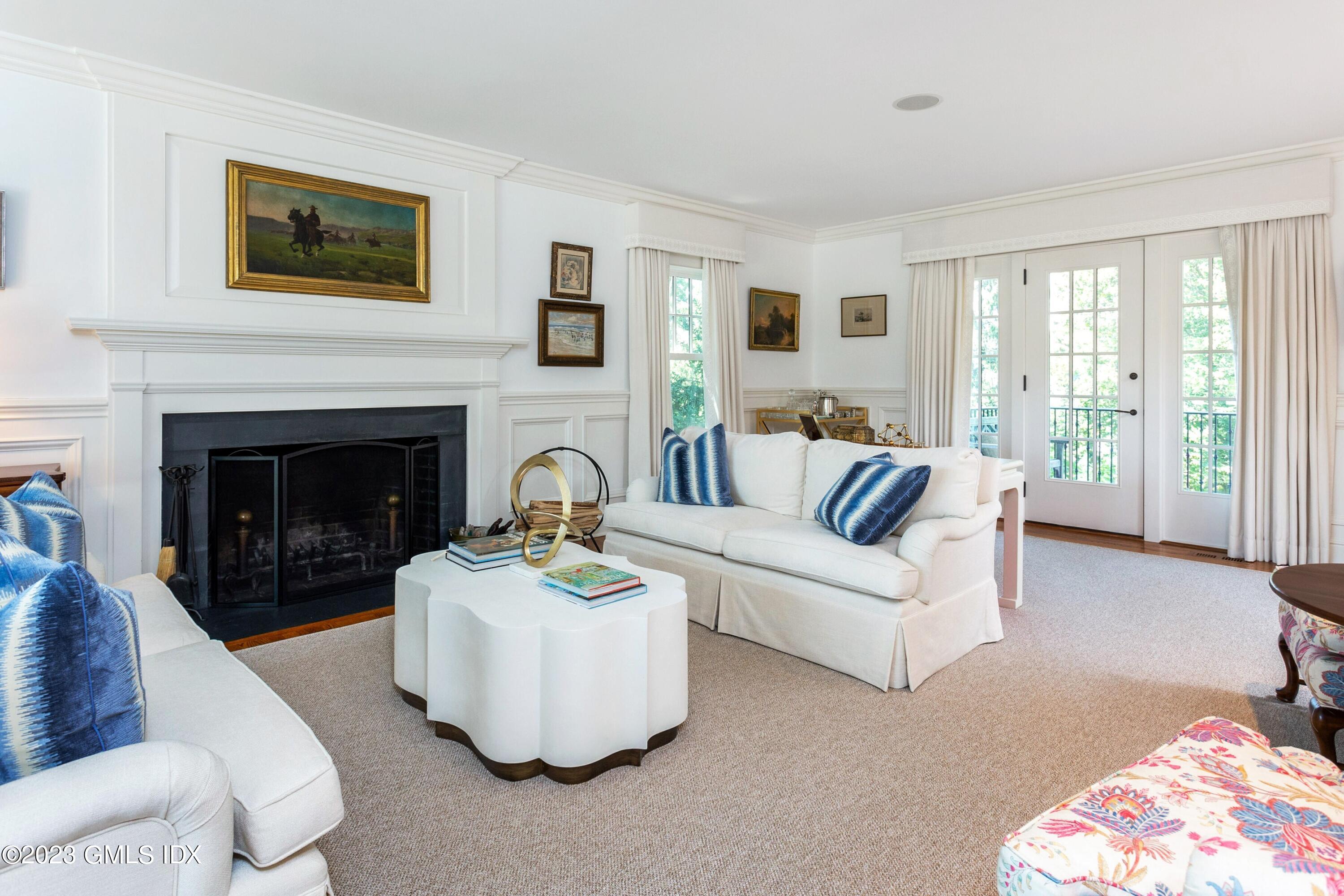150 Goodwives River Road Darien, CT 06820 - Photo 7 of 39 a living room with furniture and a fireplace