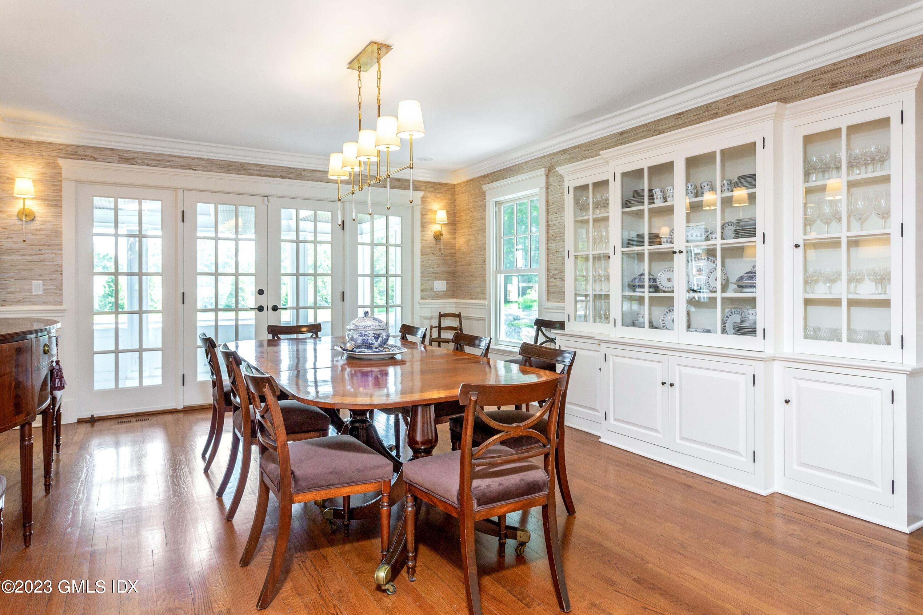 150 Goodwives River Road Darien, CT 06820 - Photo 8 of 39 a view of a dining room with furniture window and wooden floor