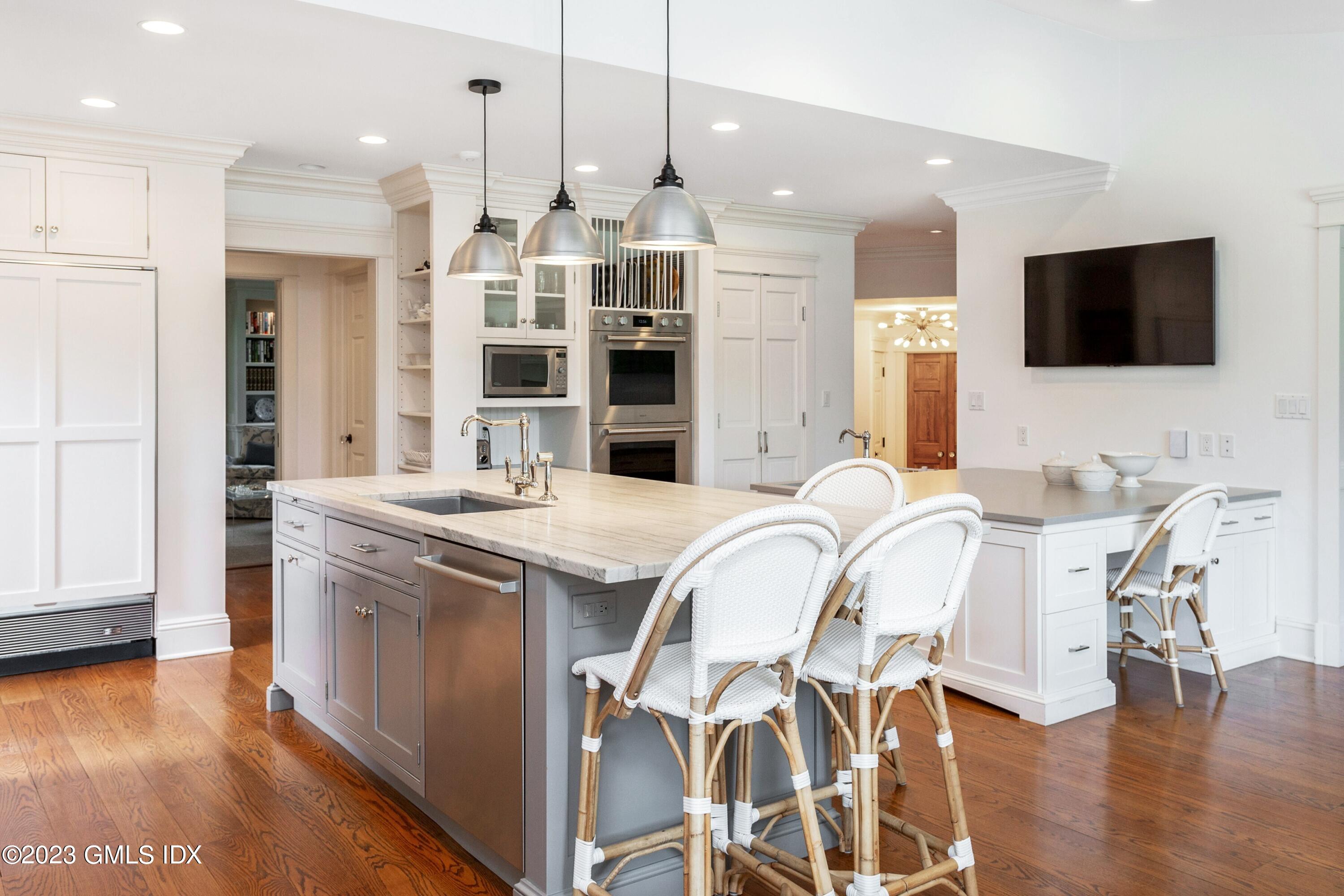 150 Goodwives River Road Darien, CT 06820 - Photo 9 of 39 a large kitchen with stainless steel appliances kitchen island granite countertop a sink and cabinets