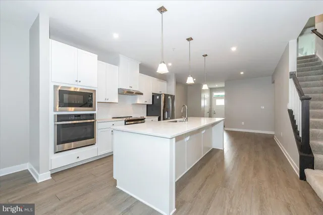 a kitchen with a stove a sink and a refrigerator