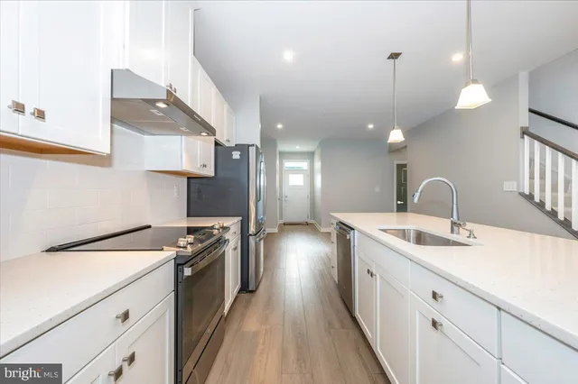 a kitchen with a sink stove and cabinets
