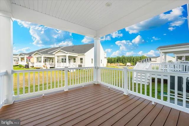 an empty room with a hallway and wooden floor