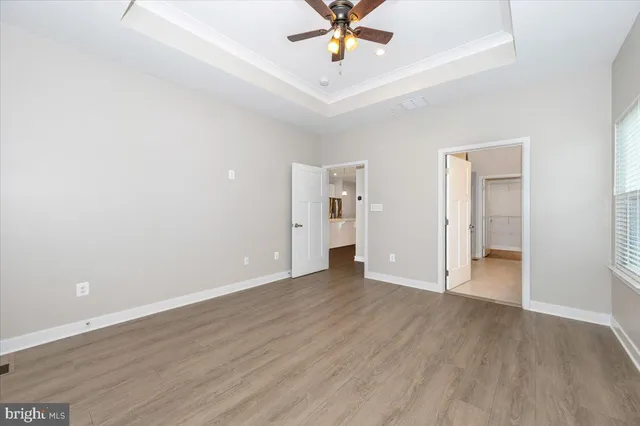 a view of a room with wooden floor