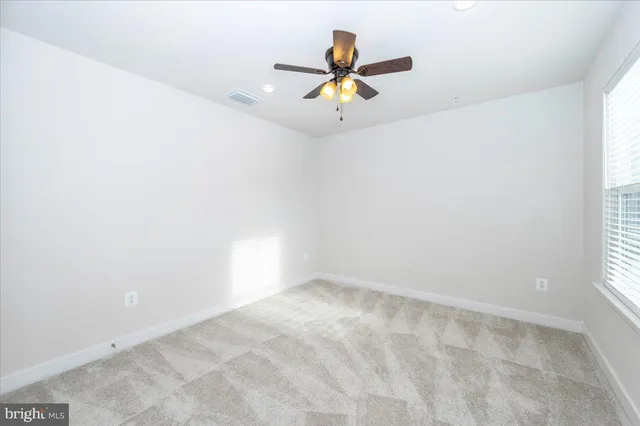 an empty room with stairs and white walls