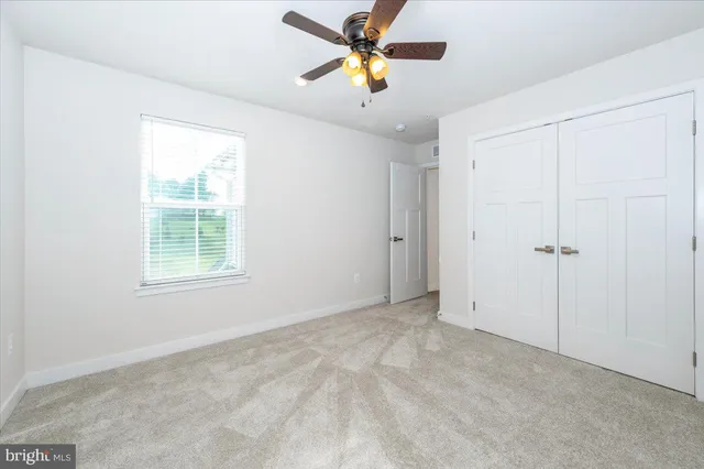 an empty room with windows and closet