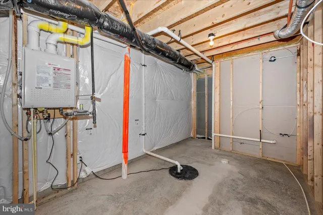 a view of a house with a yard and a large tree