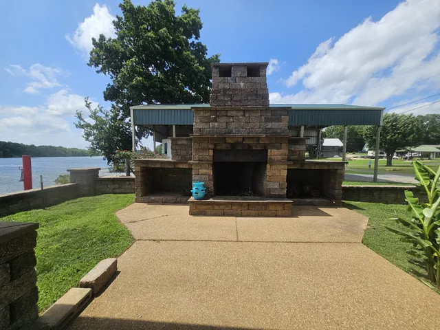 a view of a house with a yard and a fountain