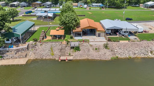 an aerial view of a house with outdoor space swimming pool and lake view