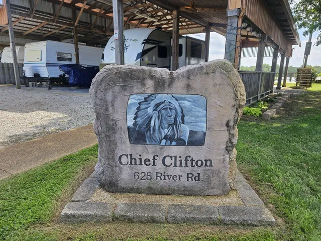 a view of chairs and table in patio with a lake view