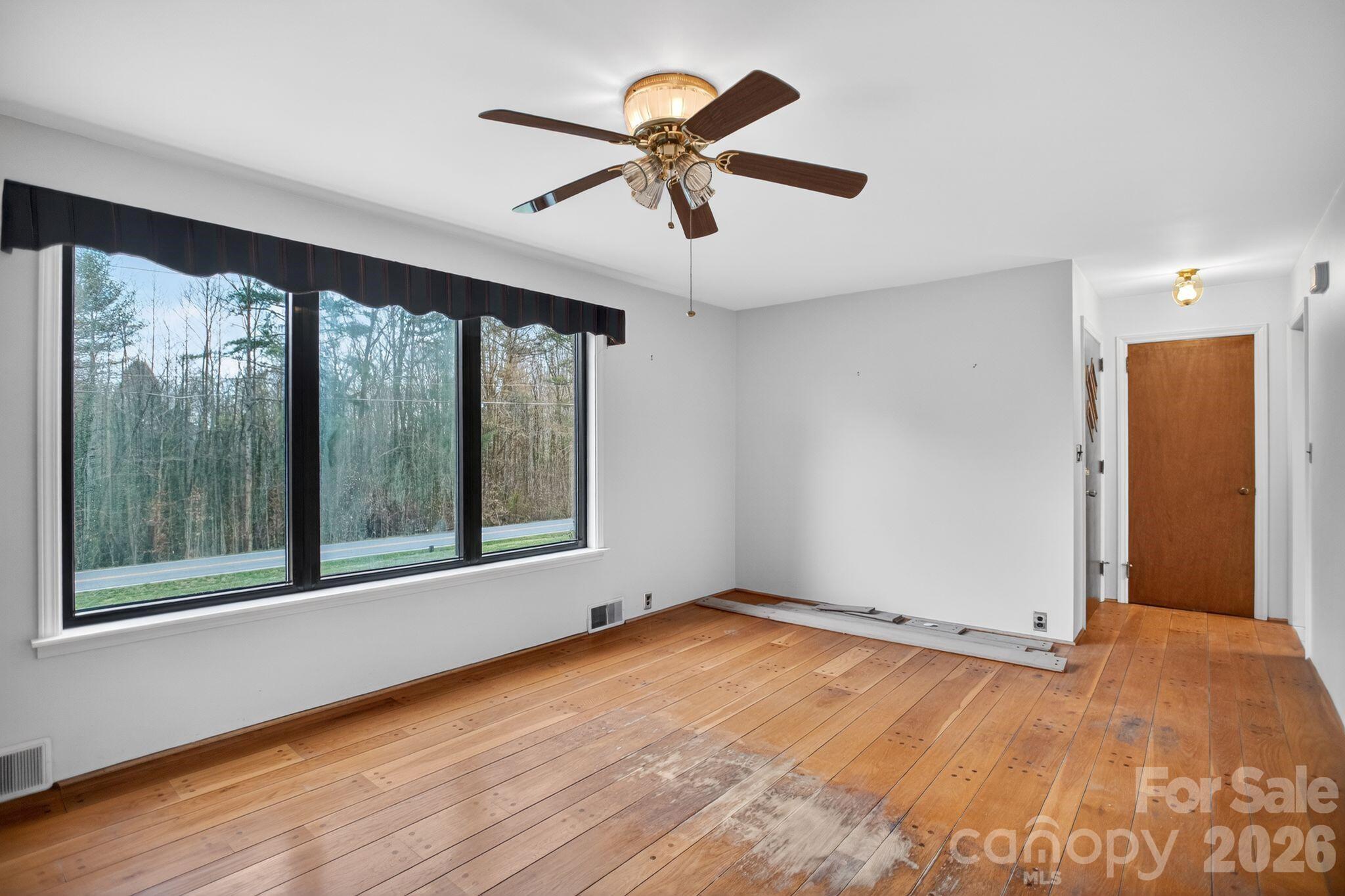 4783 Calico Road Lenoir, NC 28645 - Photo 13 of 44 wooden floor in an empty room with a window