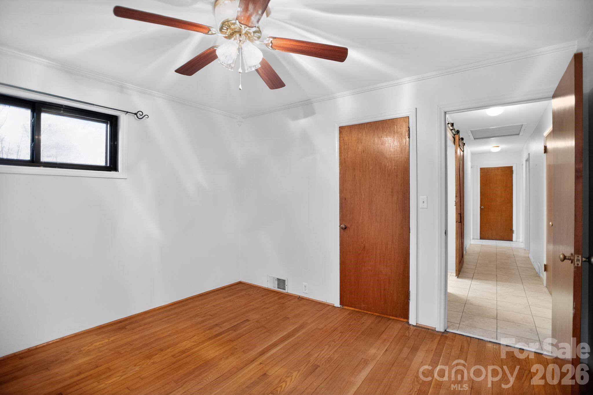 4783 Calico Road Lenoir, NC 28645 - Photo 17 of 44 a view of empty room with wooden floor