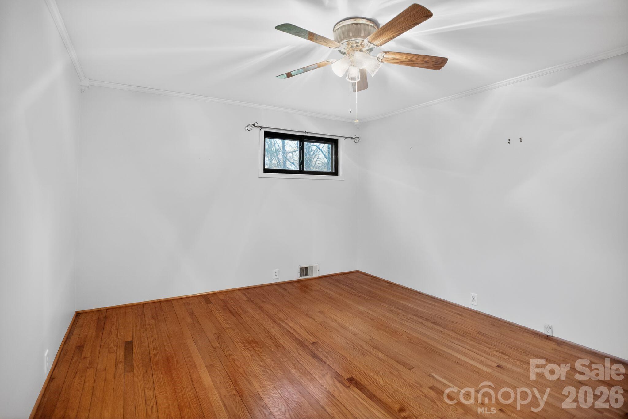 4783 Calico Road Lenoir, NC 28645 - Photo 19 of 44 an empty room with a window and a ceiling fan