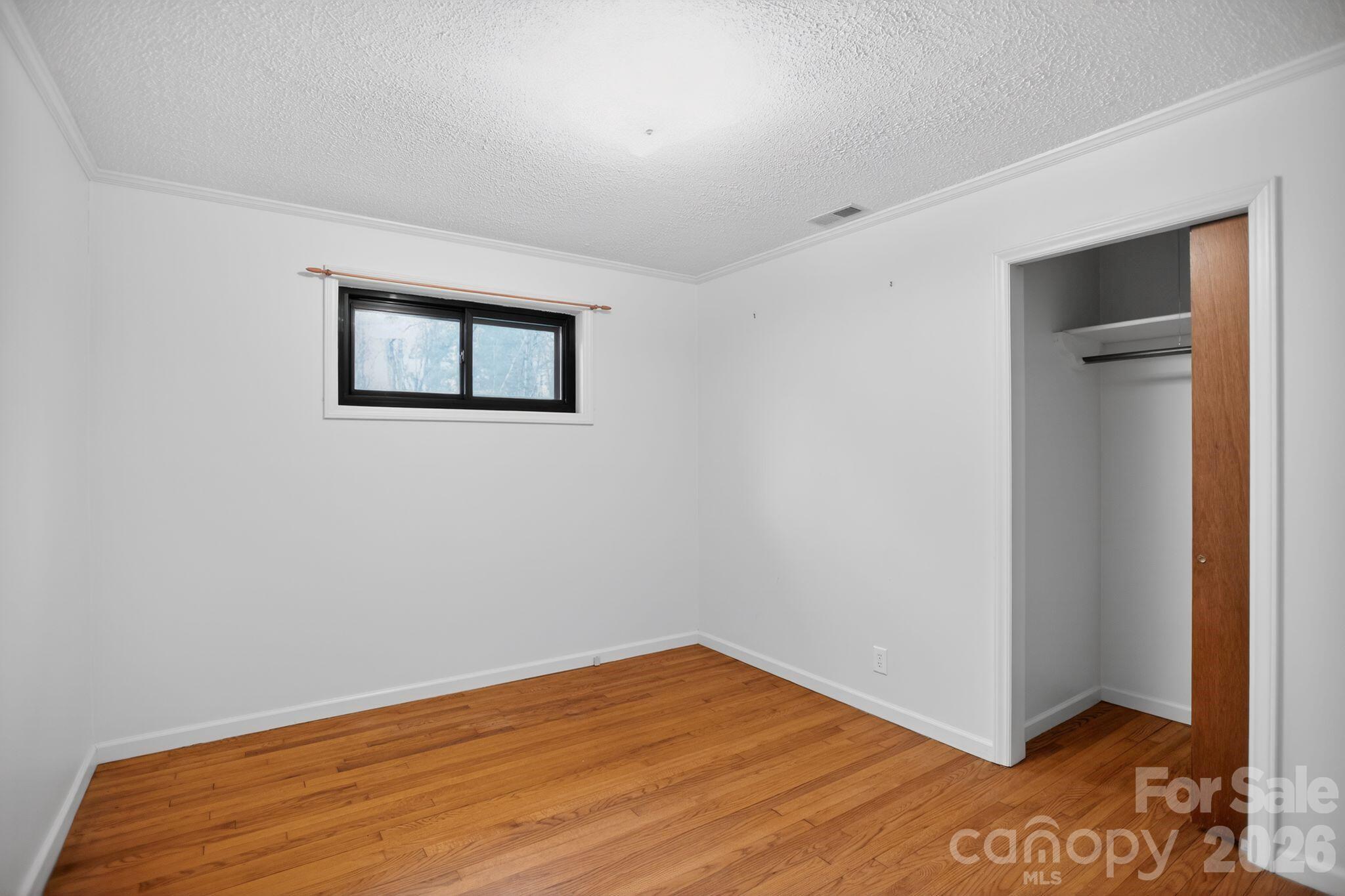 4783 Calico Road Lenoir, NC 28645 - Photo 20 of 44 a view of empty room with wooden floor