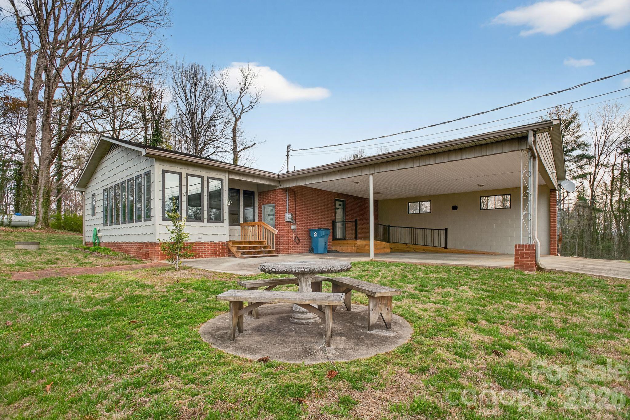4783 Calico Road Lenoir, NC 28645 - Photo 29 of 44 a front view of a house with a yard porch and outdoor seating