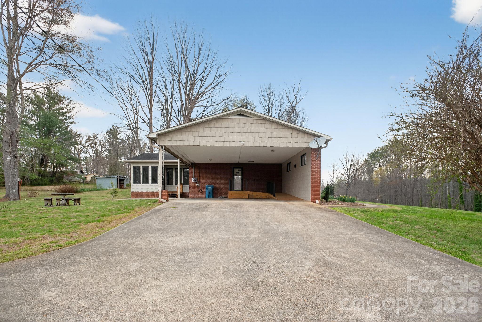 4783 Calico Road Lenoir, NC 28645 - Photo 33 of 44 a front view of a house with a yard and trees