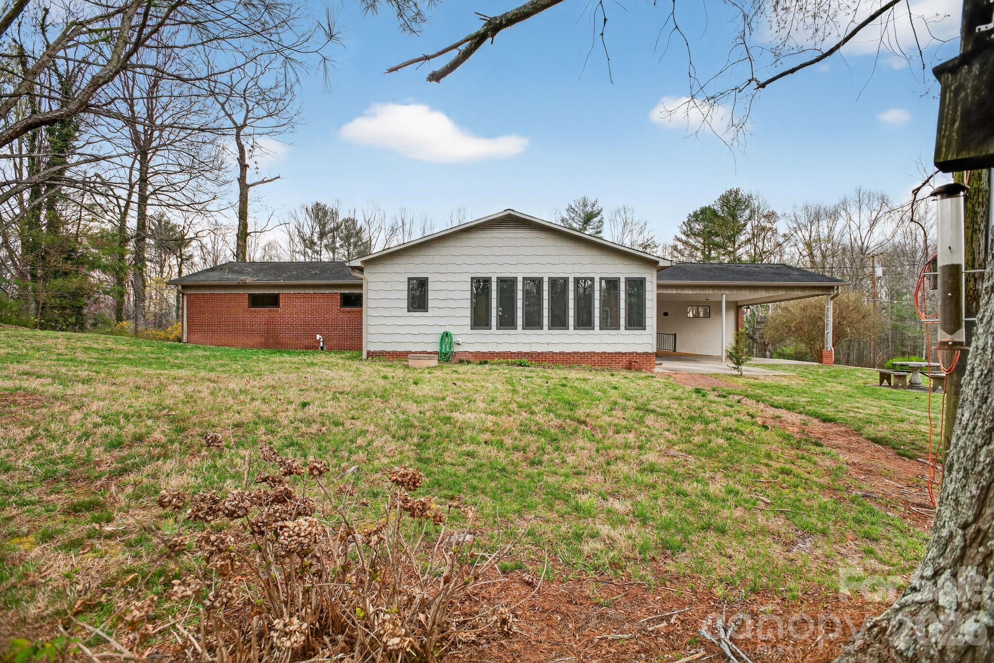4783 Calico Road Lenoir, NC 28645 - Photo 34 of 44 a front view of a house with yard and green space