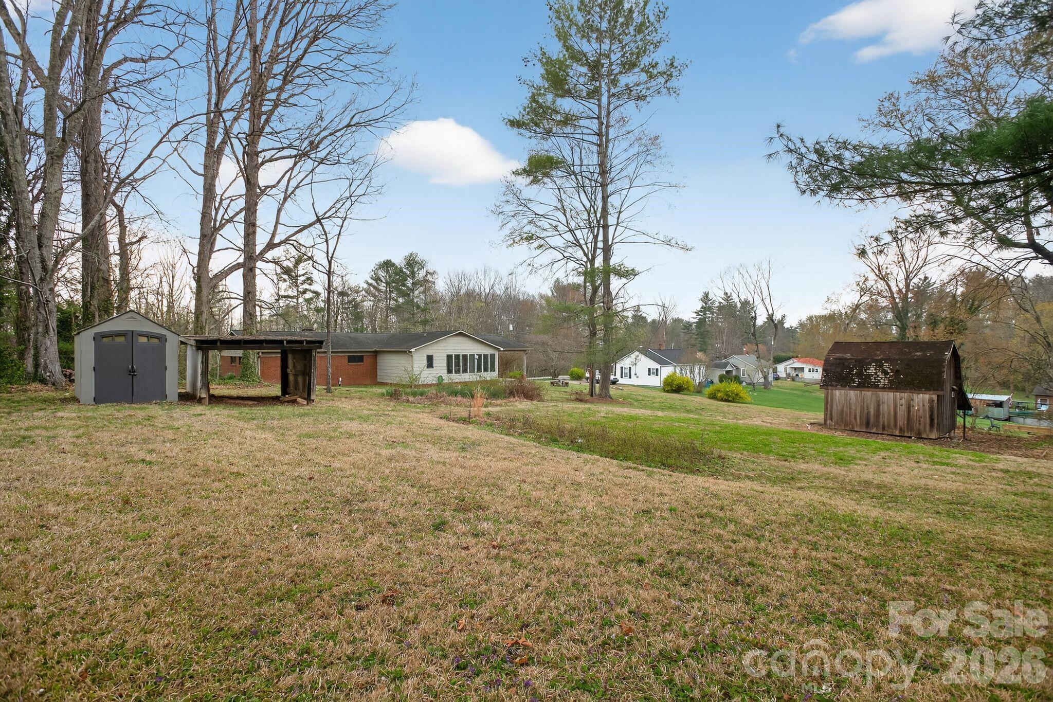 4783 Calico Road Lenoir, NC 28645 - Photo 37 of 44 a front view of a house with a yard and trees