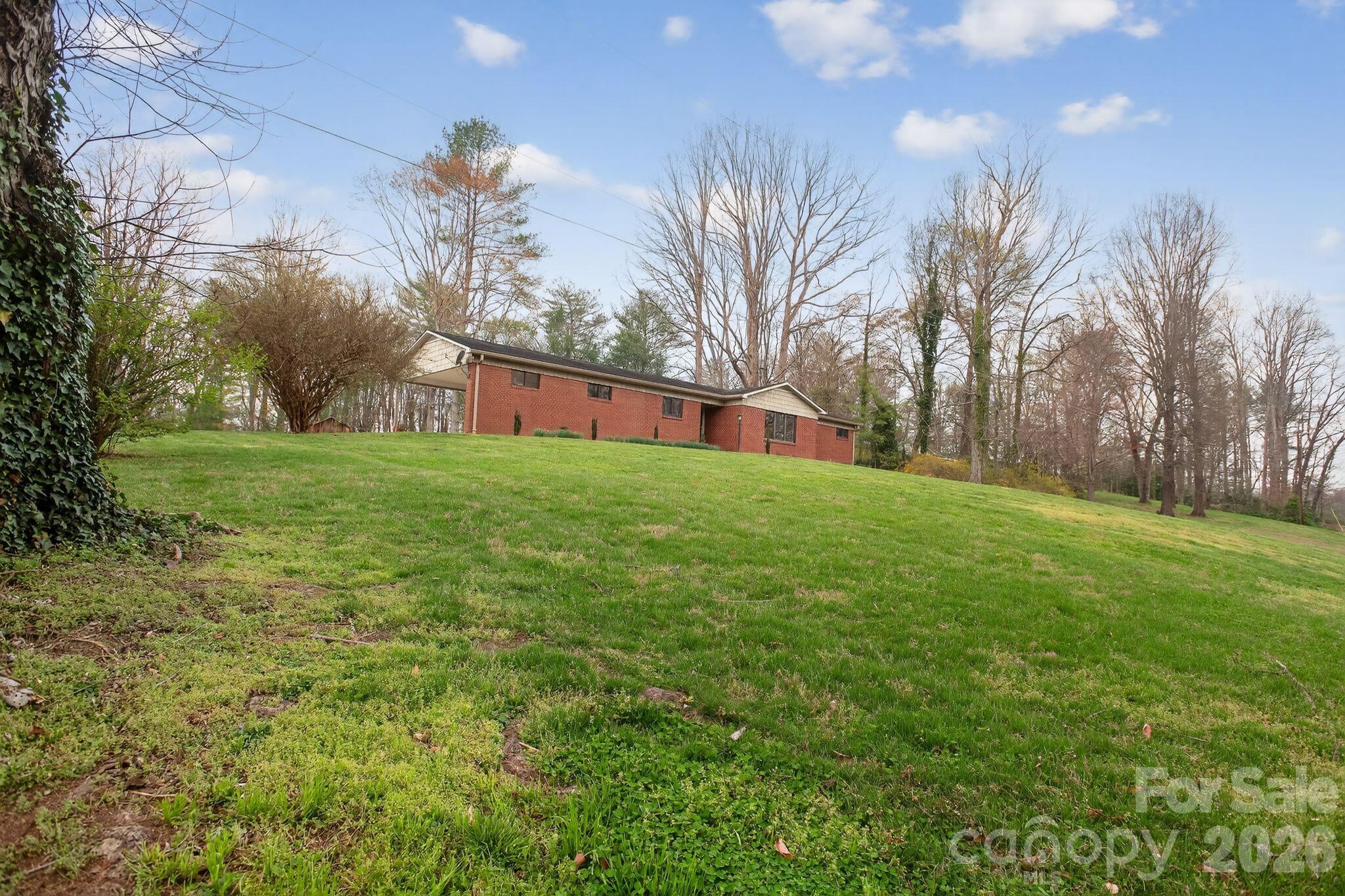 4783 Calico Road Lenoir, NC 28645 - Photo 40 of 44 a view of a backyard with palm trees