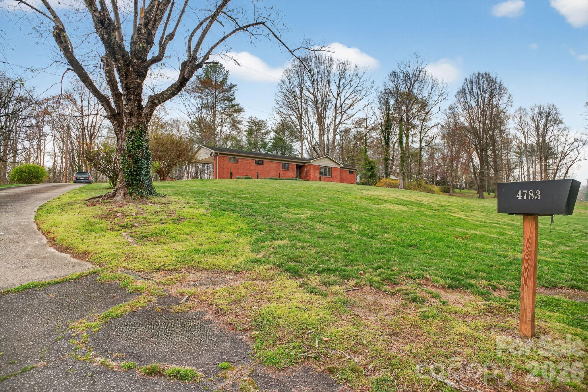 4783 Calico Road Lenoir, NC 28645 - Photo 41 of 44 a backyard of a house with lots of green space