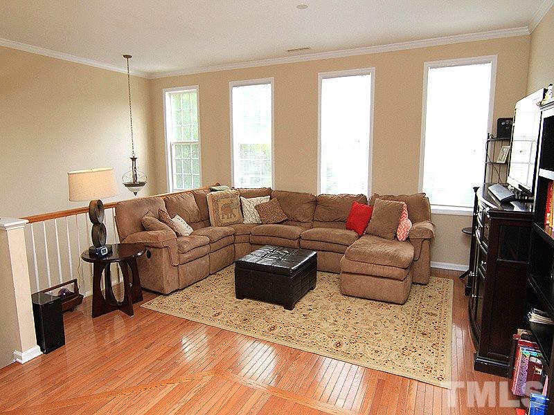 6907 Middleboro Drive Raleigh, NC 27612 - Photo 2 of 15 a living room with furniture fireplace and a flat screen tv
