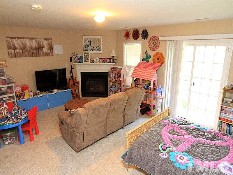 6907 Middleboro Drive Raleigh, NC 27612 - Photo 11 of 15 a living room with furniture and a fireplace