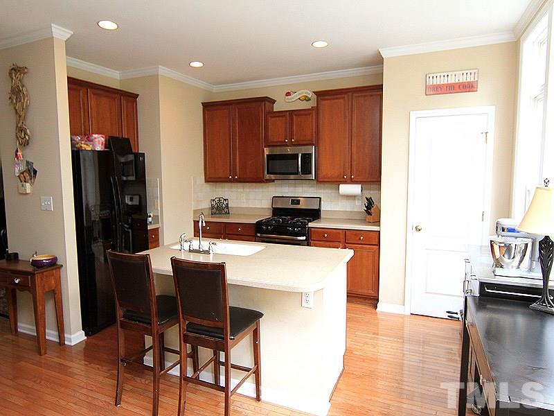 6907 Middleboro Drive Raleigh, NC 27612 - Photo 5 of 15 a kitchen with stainless steel appliances granite countertop a refrigerator a stove top oven a sink and dishwasher