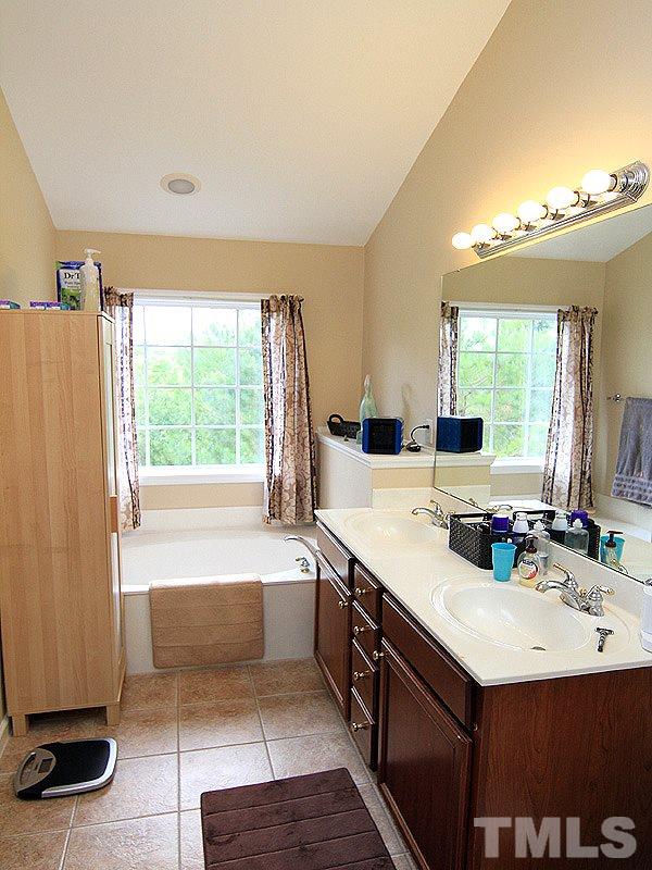 6907 Middleboro Drive Raleigh, NC 27612 - Photo 8 of 15 a bathroom with a sink double vanity and a bathtub
