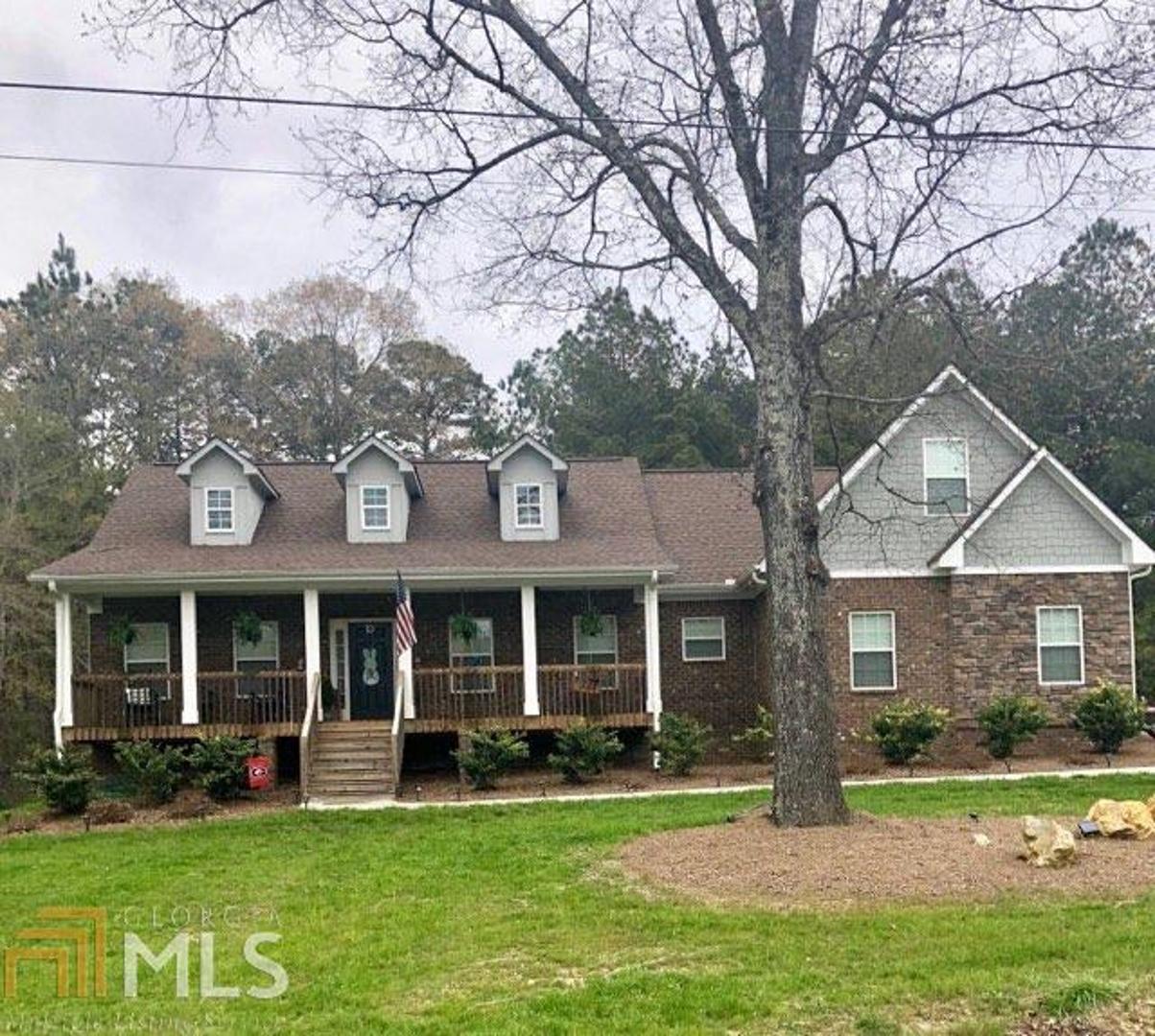 a front view of a house with a garden and porch