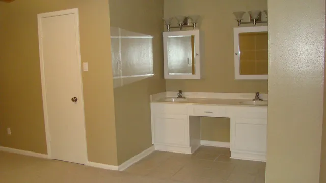 a bathroom with a sink vanity and mirror