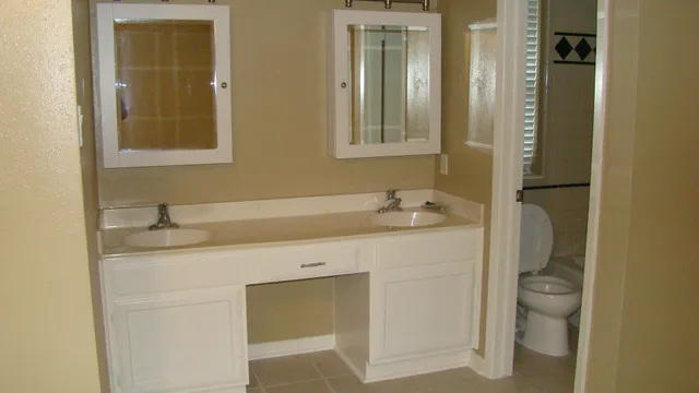 a bathroom with a granite countertop sink toilet and mirror