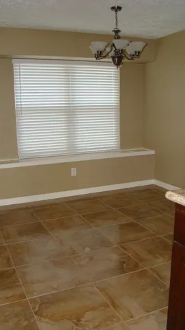 a view of a room with window and a ceiling fan