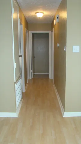 a view of a room with wooden floor