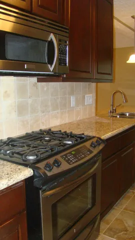 a stove top oven sitting inside of a kitchen