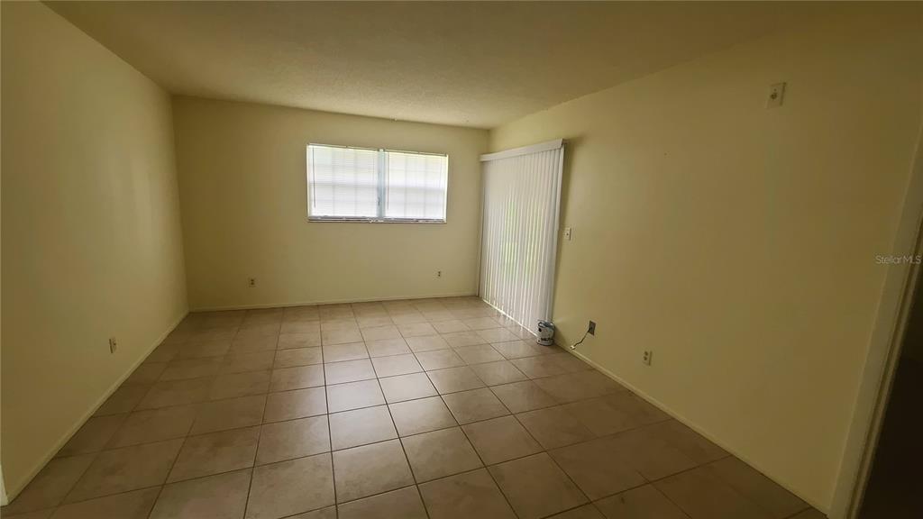 454 Fairways Circle, Unit B102 Ocala, FL 34472 - Photo 5 of 7 a view of a small space with wooden floor and a window