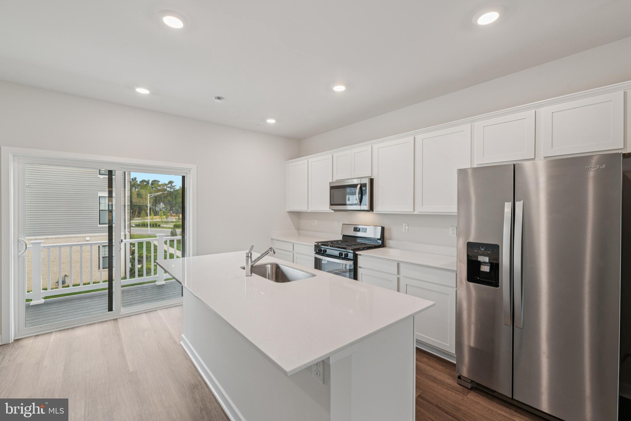 7406 Calm Retreat Boulevard Brandywine, MD 20613 - Photo 14 of 37 a kitchen with stainless steel appliances a refrigerator and a stove top oven