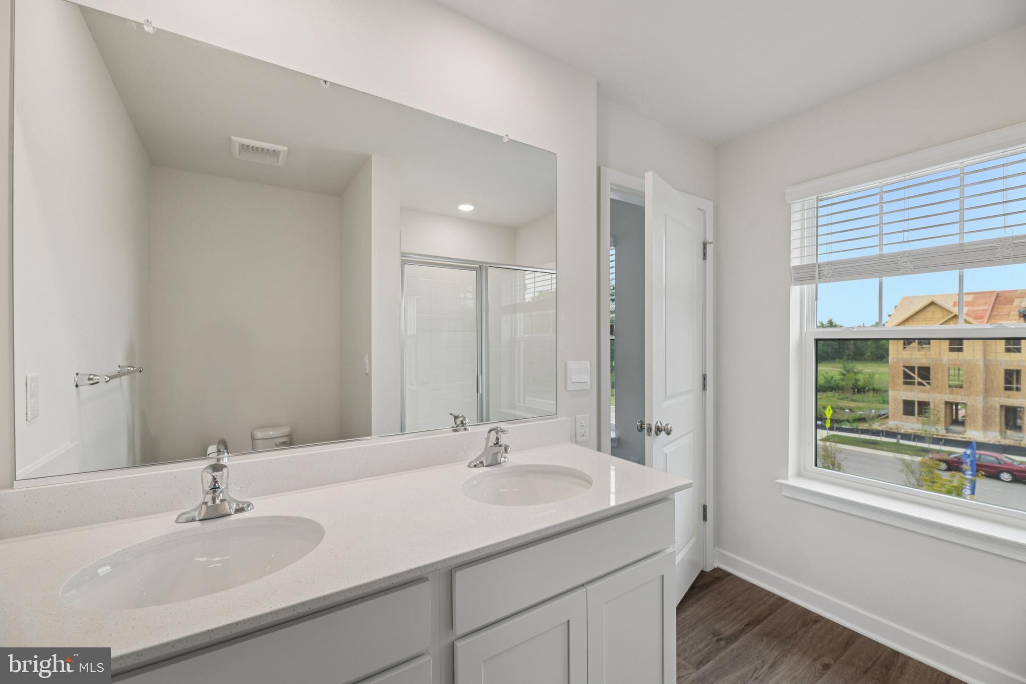 7406 Calm Retreat Boulevard Brandywine, MD 20613 - Photo 26 of 37 a bathroom with a sink double vanity and a shower