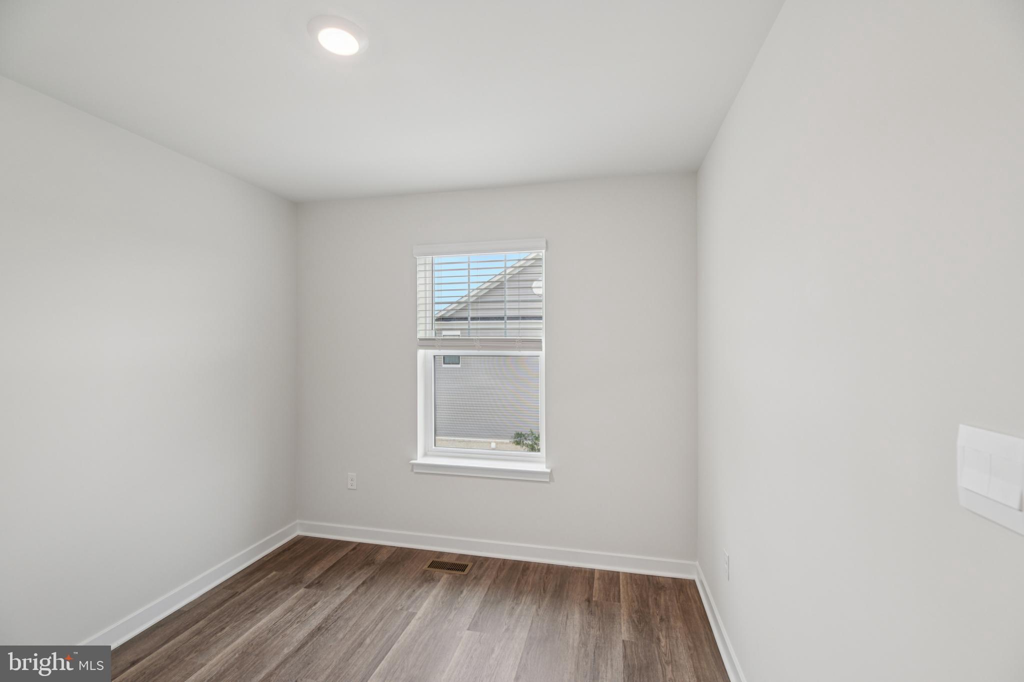 7406 Calm Retreat Boulevard Brandywine, MD 20613 - Photo 29 of 37 a view of an empty room with wooden floor and a window
