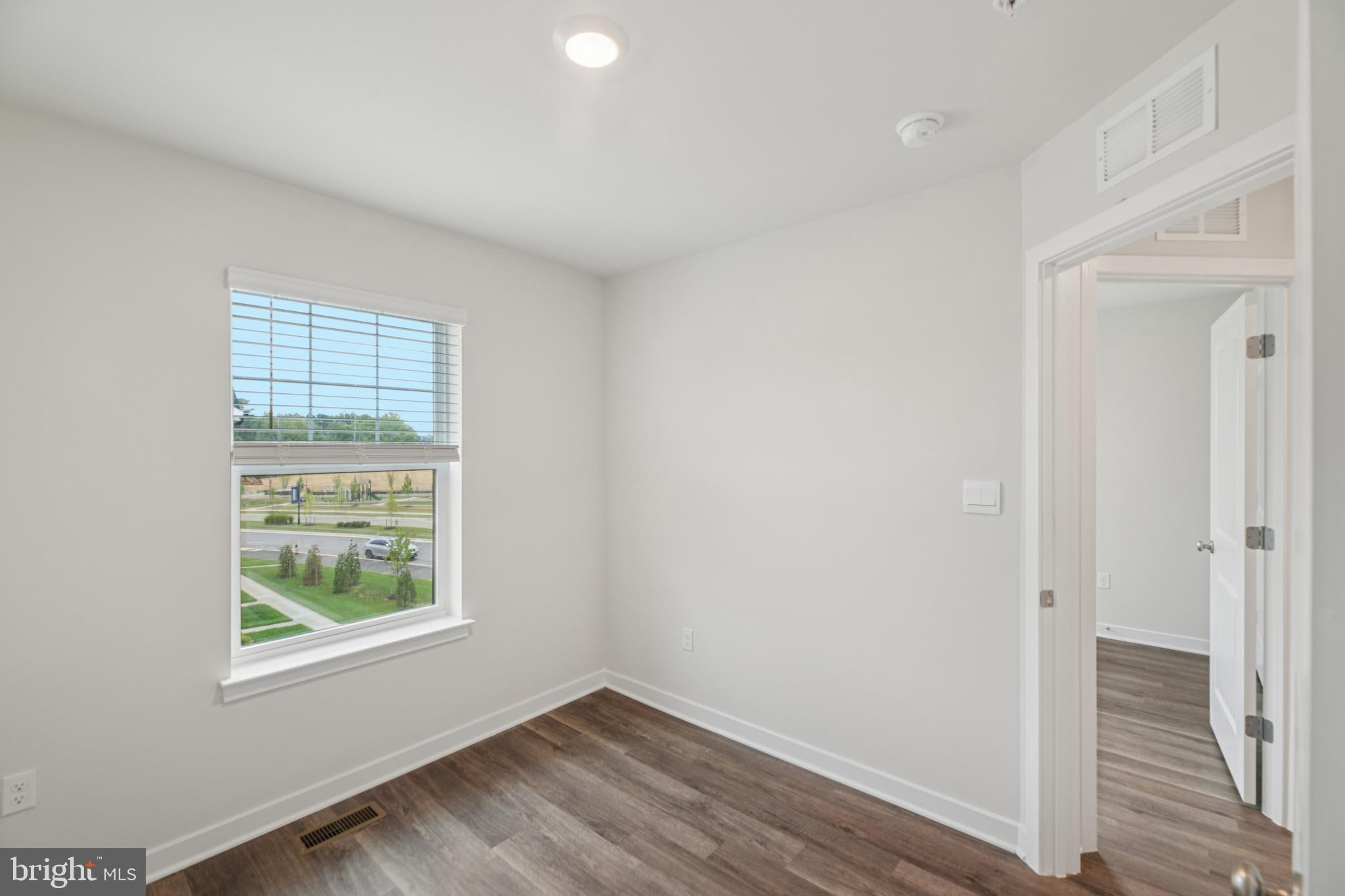 7406 Calm Retreat Boulevard Brandywine, MD 20613 - Photo 31 of 37 a view of an empty room with wooden floor and a window