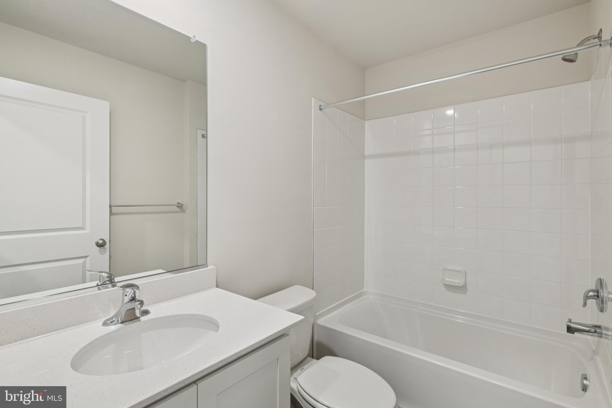 7406 Calm Retreat Boulevard Brandywine, MD 20613 - Photo 7 of 37 a bathroom with a sink toilet and shower