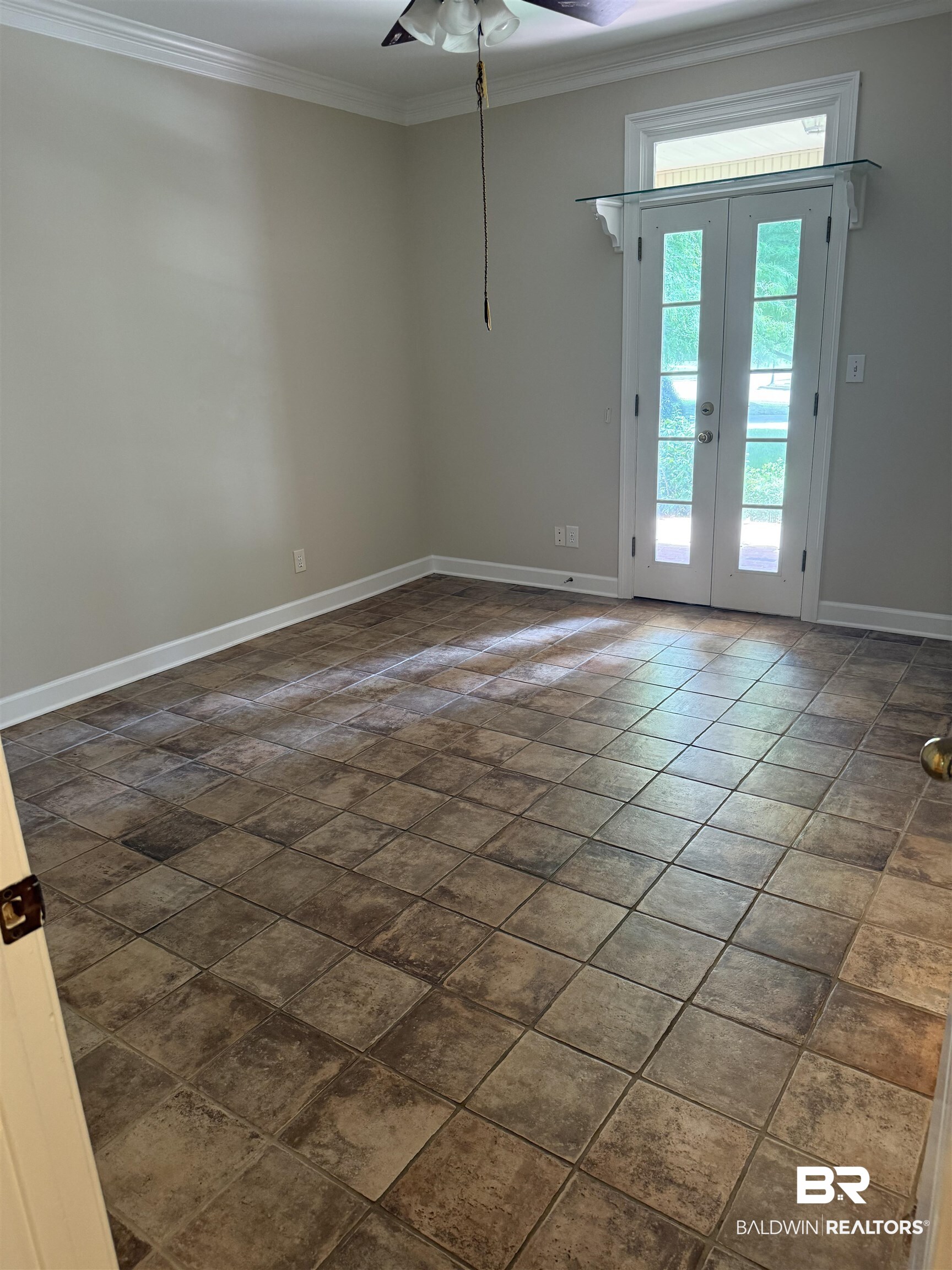 508 Barbara Court Daphne, AL 36526 - Photo 11 of 16 Unfurnished room featuring a ceiling fan, ornamental molding, and dark stone finish flooring