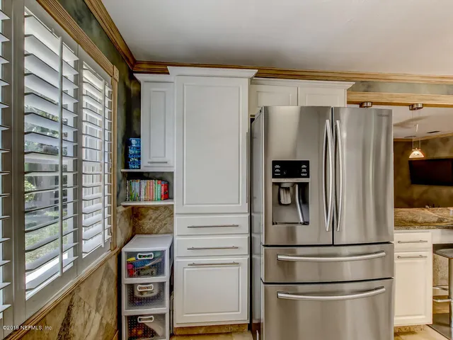 a bedroom with a bed chairs and a window