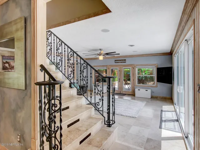 a white bath tub sitting next to a white toilet and sink